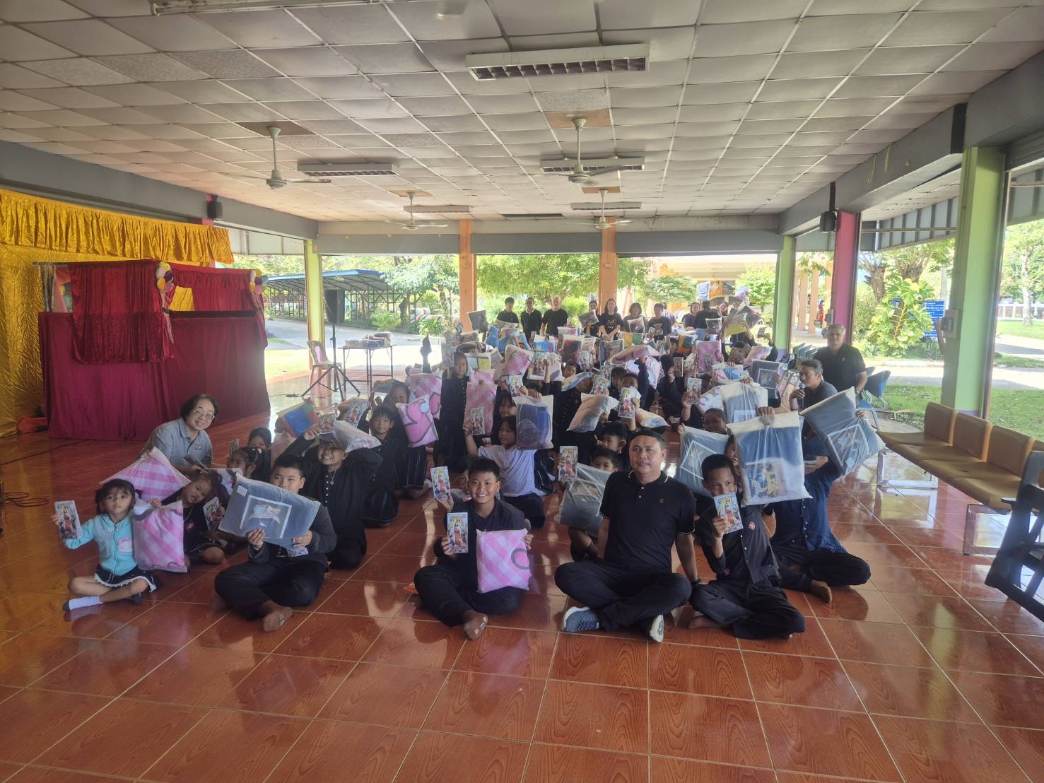 Children with donated bed linen at a school in Thailand